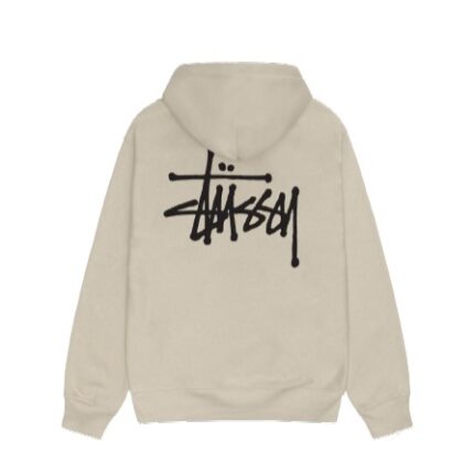 Close-up of Stüssy men’s collection: a hoodie, graphic tee, cargo pants, and accessories showcasing urban, relaxed style with earthy tones.