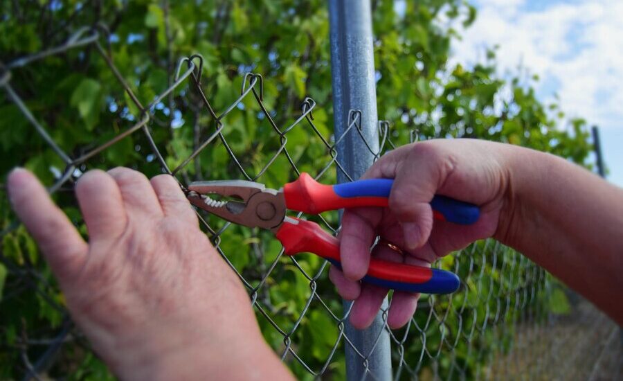 womans-hands-working-field-with-pliers-wire_