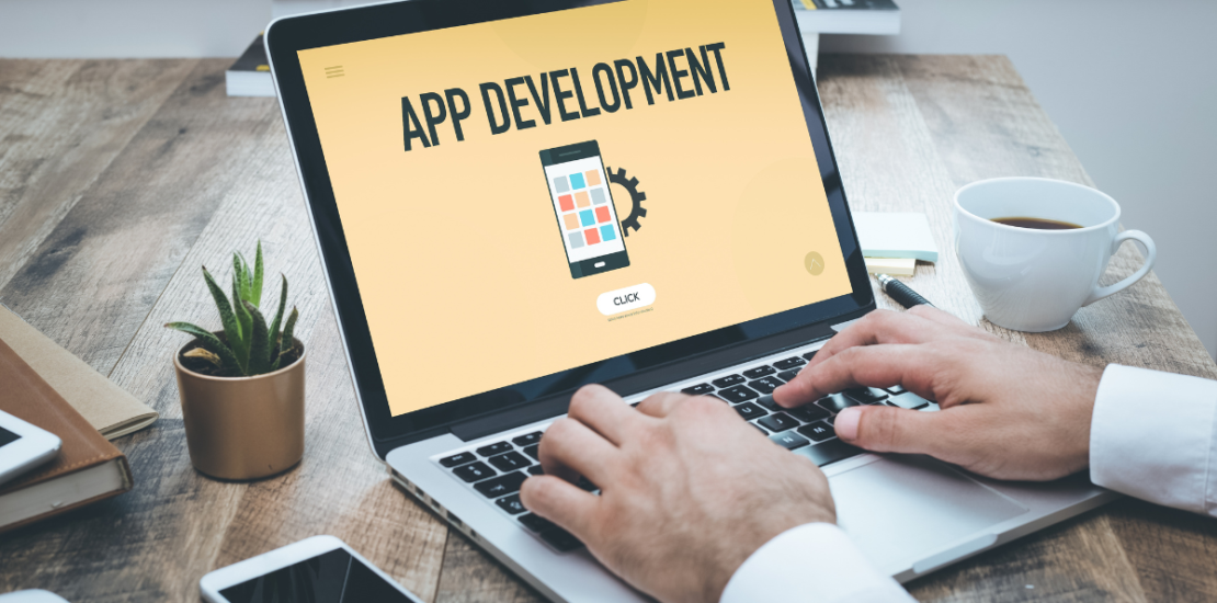 App development concept on a laptop screen, showcasing mobile application design and coding for business growth and digital transformation.