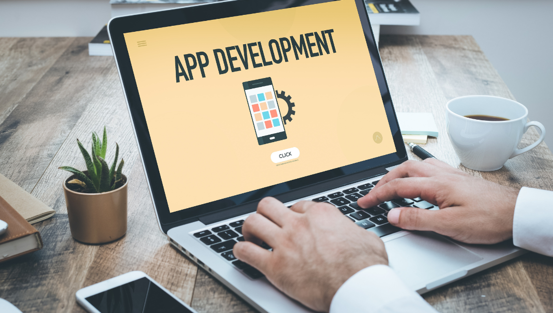 App development concept on a laptop screen, showcasing mobile application design and coding for business growth and digital transformation.
