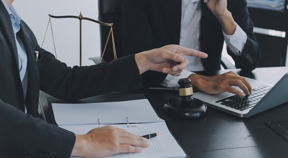 a labor lawyer consults with their client