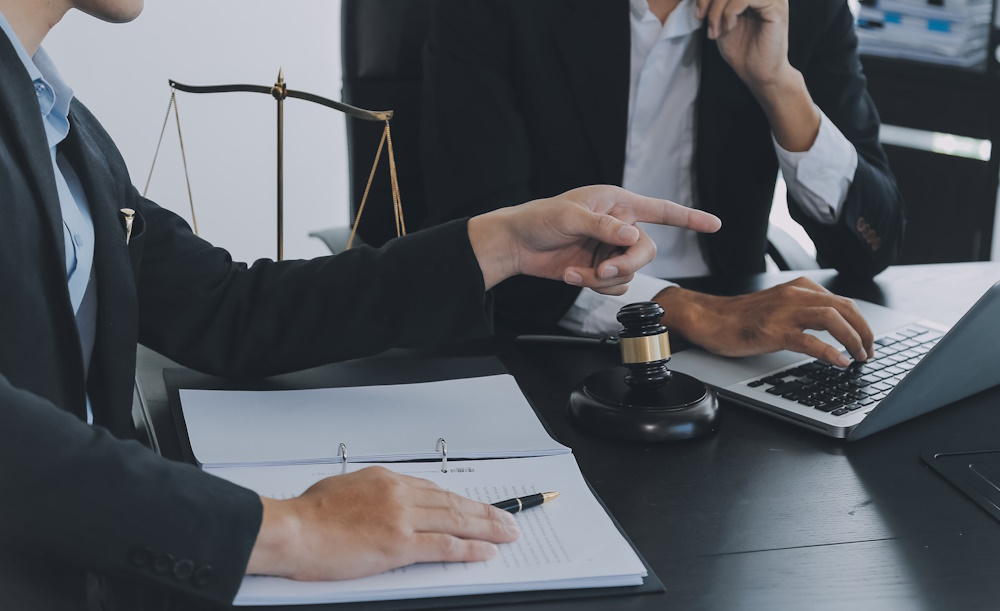 a labor lawyer consults with their client